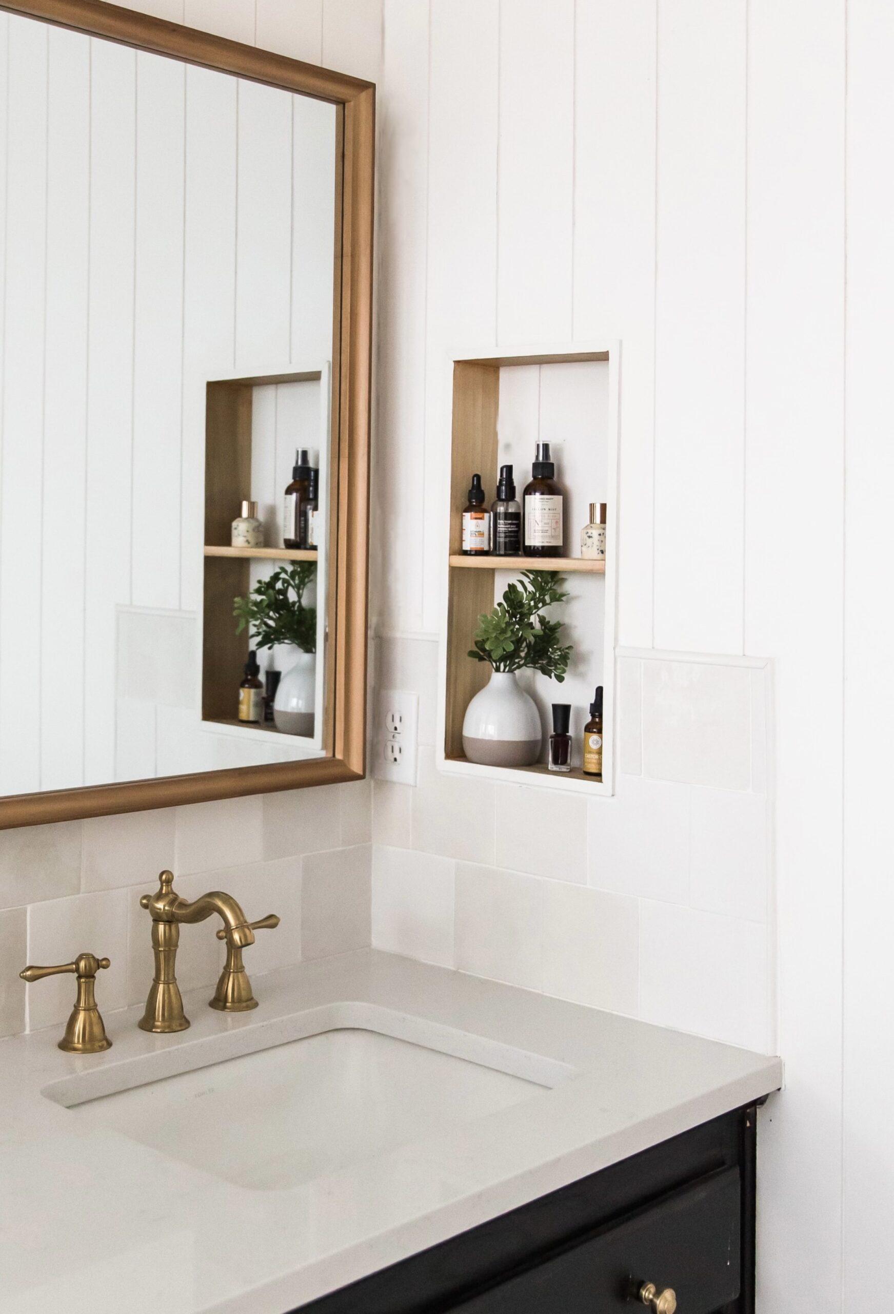 Black vanity white countertops primary bathroom antique brass faucet inset shelf